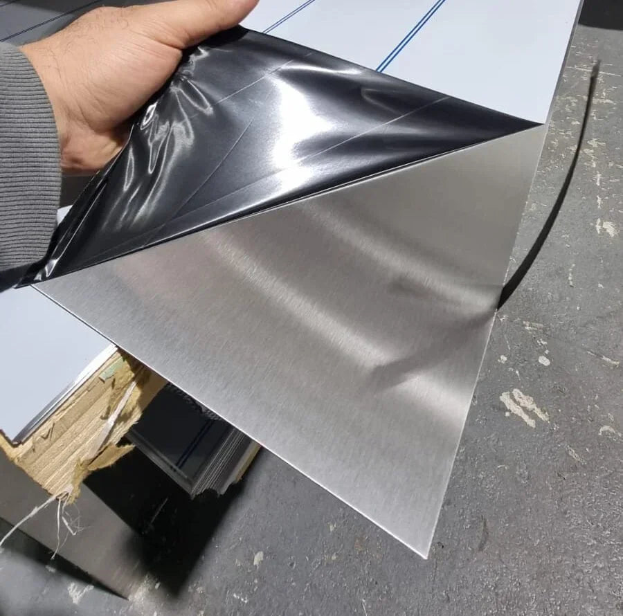 Brushed aluminum sheet with protective film being peeled, showcasing metallic finish and industrial use