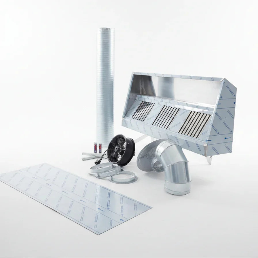 Ventilation system components on a concrete floor with a brick wall and metal duct in the background.
