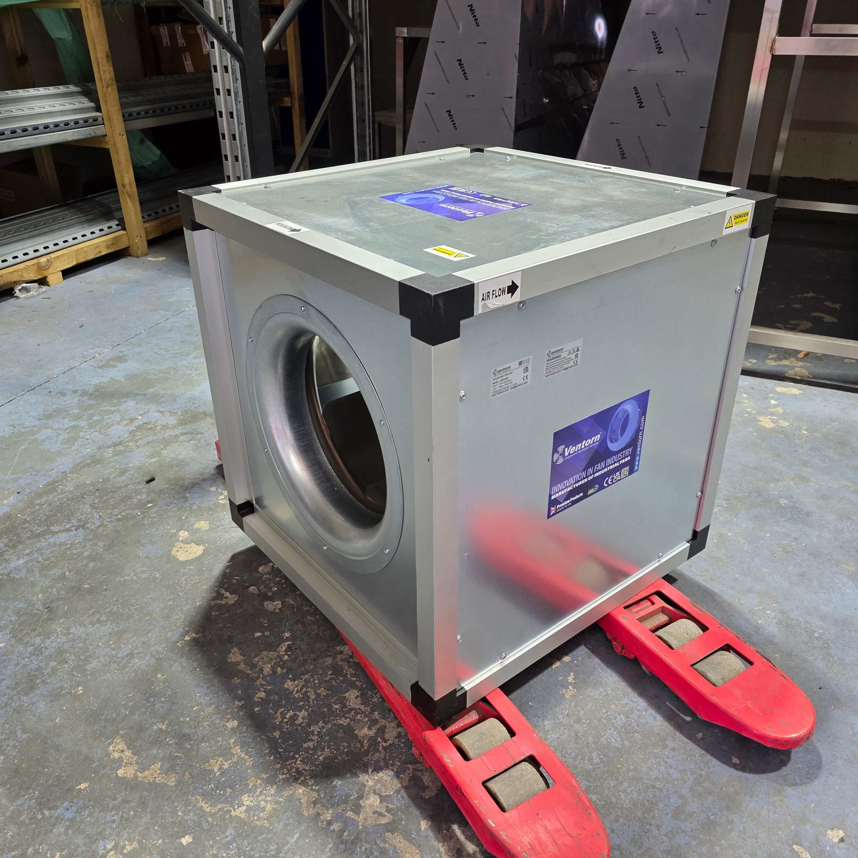 Ventorn industrial fan unit on red pallet jack in warehouse, air flow directional label visible